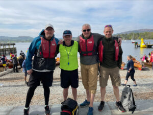 Team of rowers in lifejackets on the shore