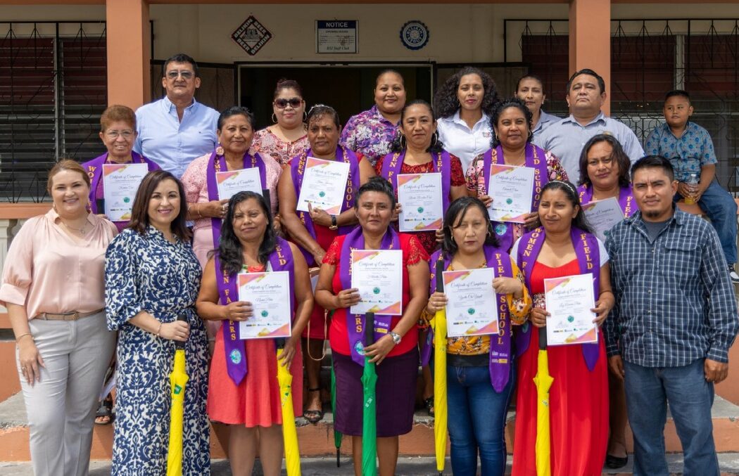 Group photo of female sugar cane farmers in Belize at their graduation