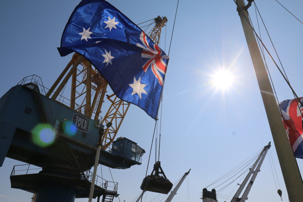 Australian flag flutters in front of Tate & Lyle crane