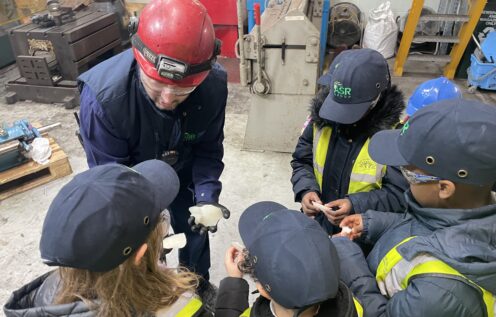 Engineer shows children a spanner