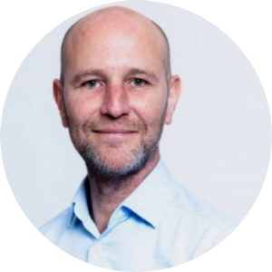 Head-and-shoulders portrait of a person in a light blue collared shirt.