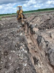 Agricultural machine digging a trench in the soil