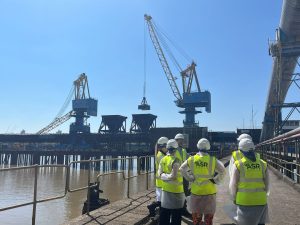 Work experience students in front of Tate & Lyle cranes