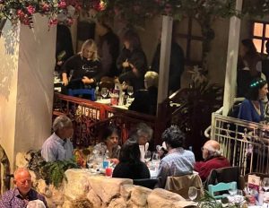 VIPON members eat dinner in a Mamma Mia, greek-themed restaurant