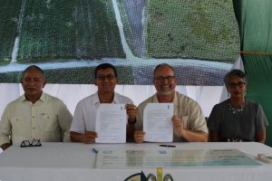 Sugarcane farmers sat with Belize's prime minister at grant ceremony
