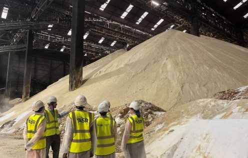 Work experience students looking at raw sugar shed