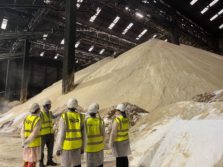 Work experience students looking at raw sugar shed